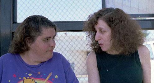 Beth and Rachel sitting at the bus stop.